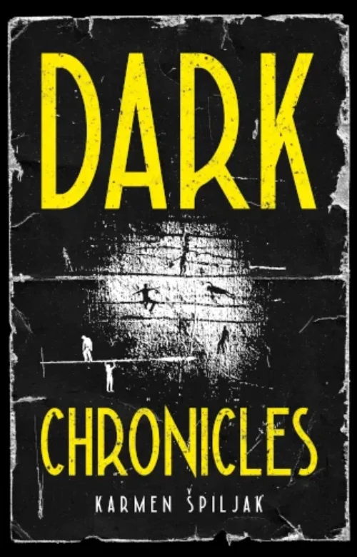 Cover with black background and a stage lighted part in the middle, showing figures falling. Dark Chronicles written in yellow letters